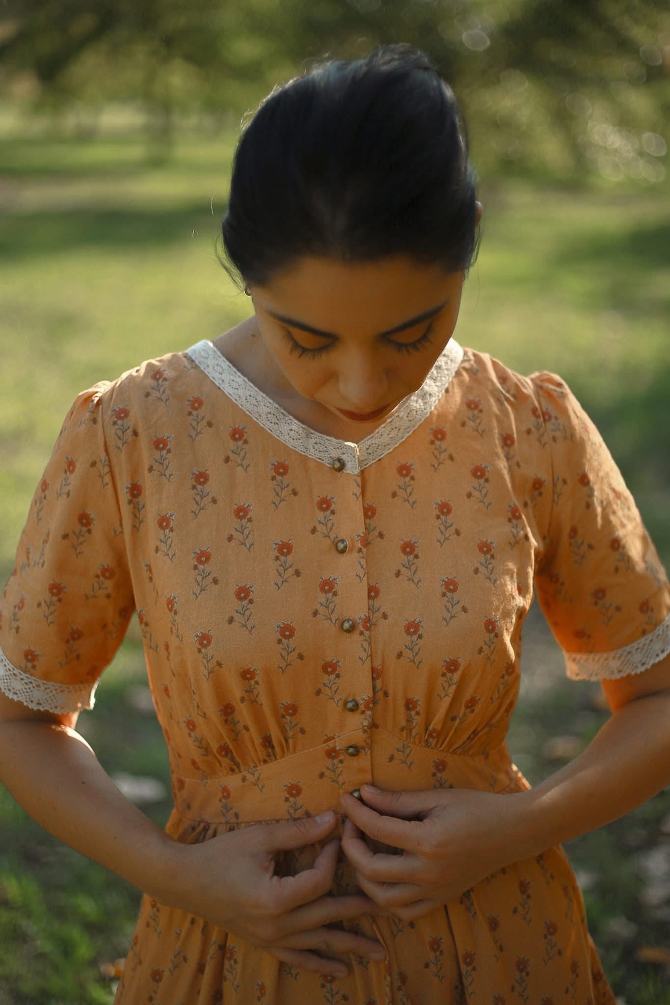 Woman in modest nursing dress grassy field