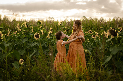 Two women in modest nursing dresses in field