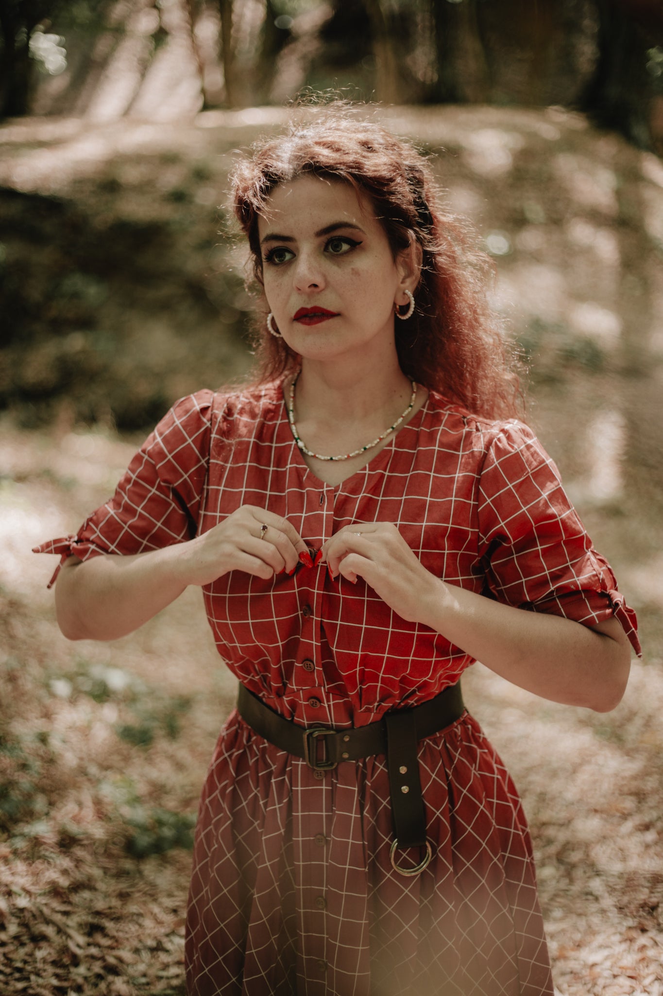 Woman in modest nursing red checkered dress outdoors