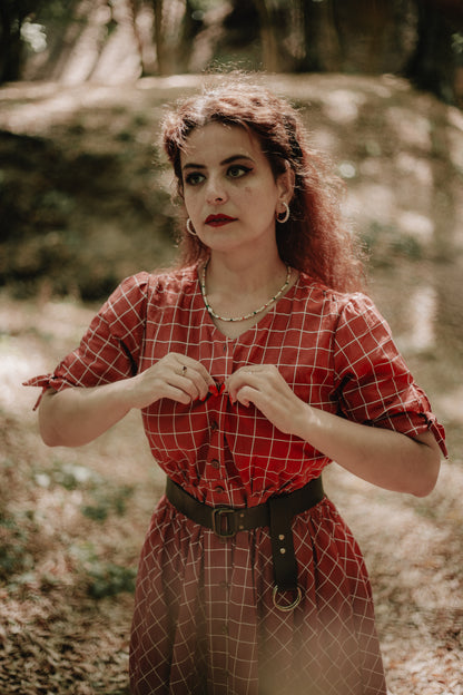 Woman in modest nursing red checkered dress outdoors