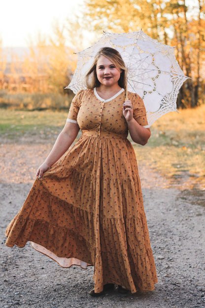 Woman modest nursing dress umbrella natural setting