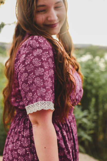 Woman wearing modest purple nursing dress outdoors