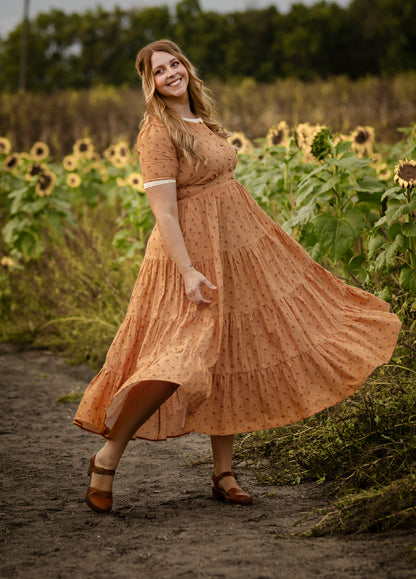 Woman in modest nursing dress sunflower field