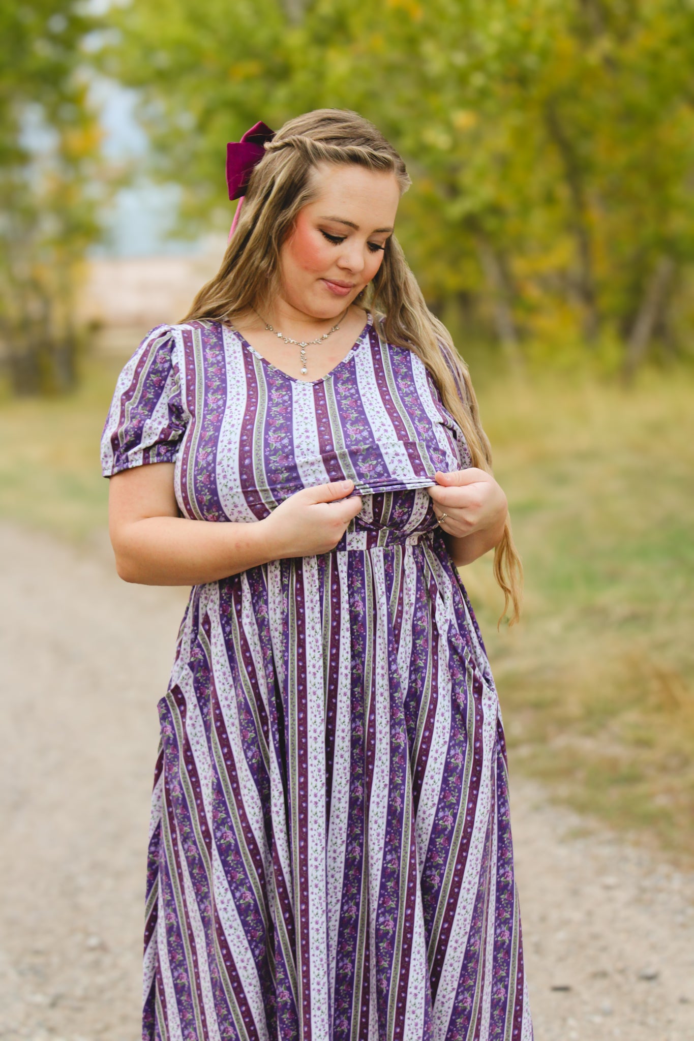 woman wearing a modest nursing purple and white striped dress