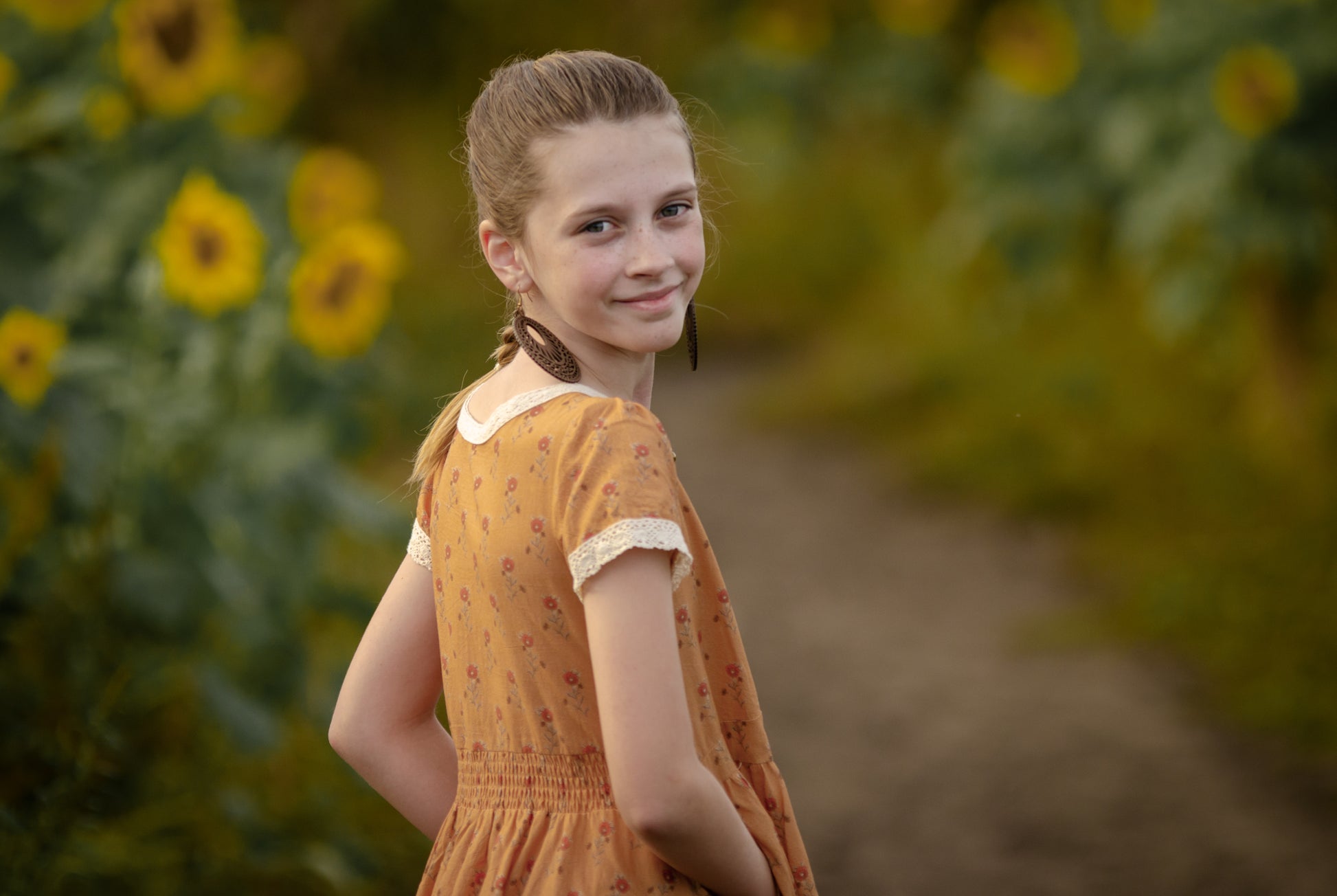 Young girl in modest dress with sunflowers