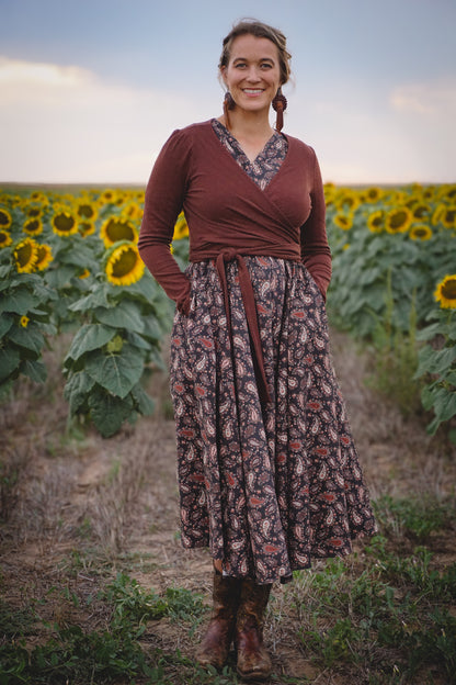 Woman in modest nursing dress in sunflower field