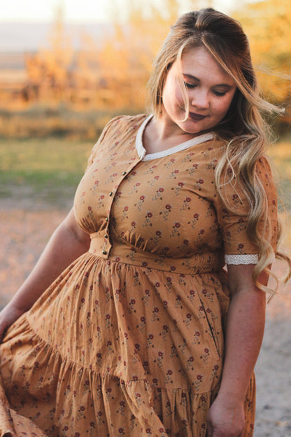 Woman in modest nursing dress outdoor setting