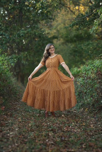 Woman in modest nursing dress standing in forest