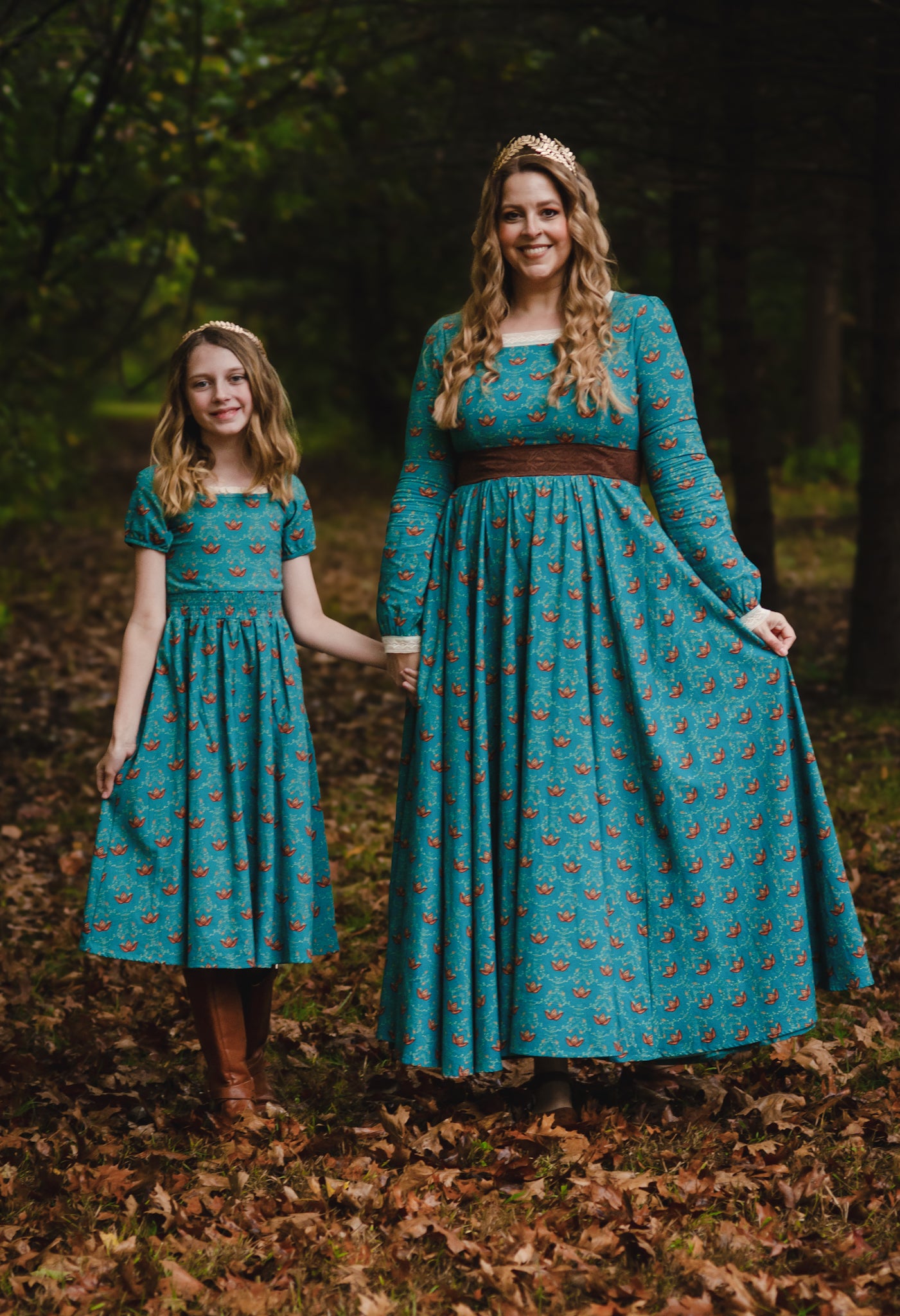 Mother and daughter wearing modest nursing dresses in forest.