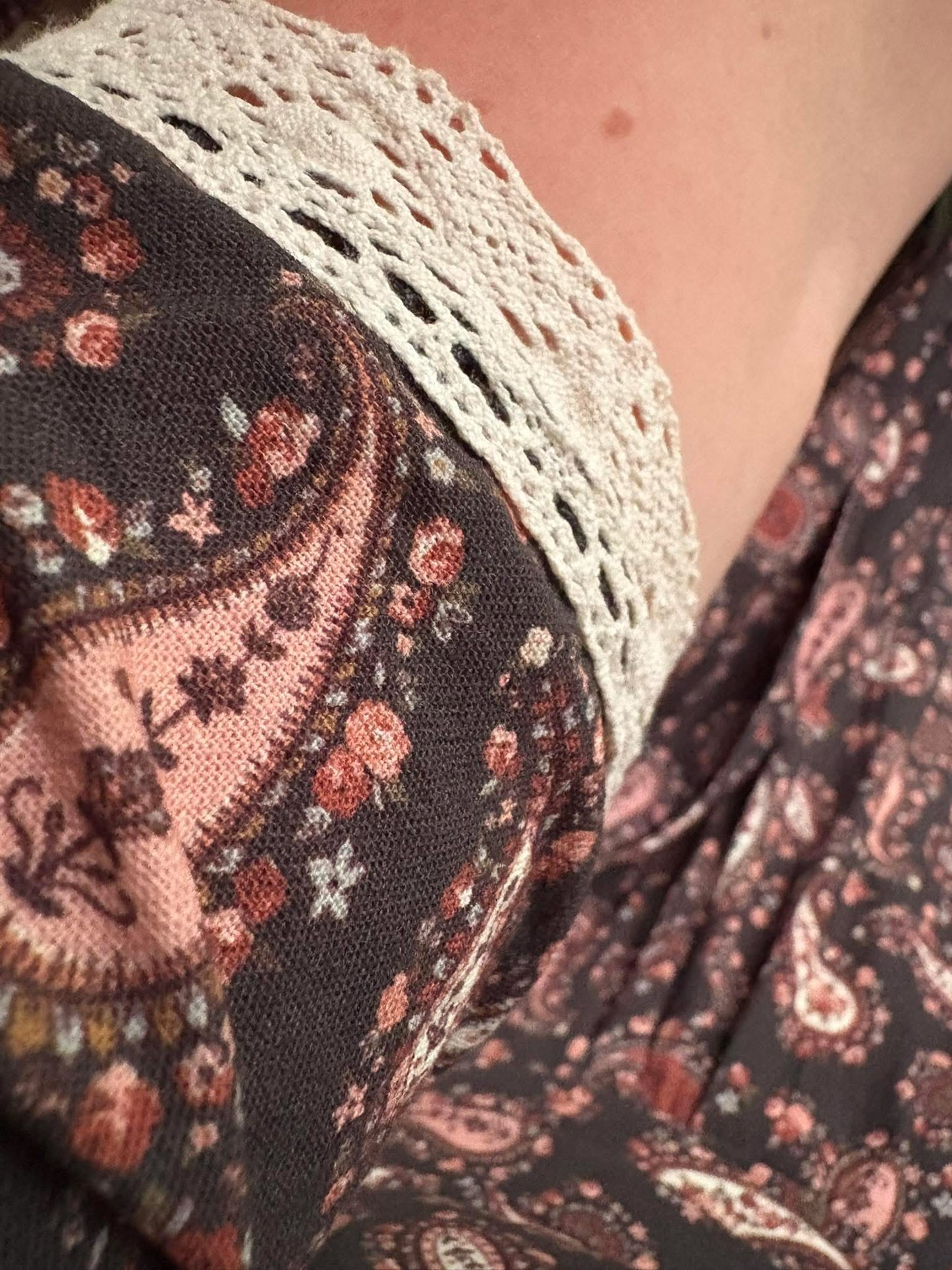 Floral patterned fabric with lace detailing close-up