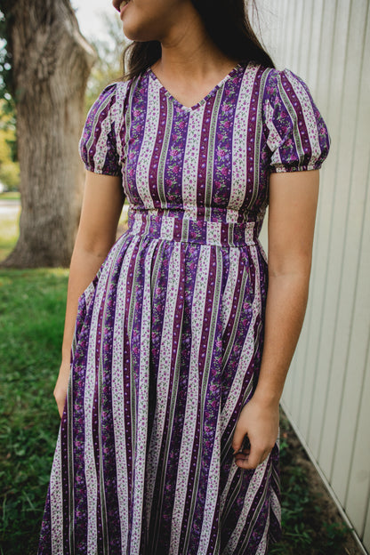 woman wearing a modest nursing purple and white striped dress