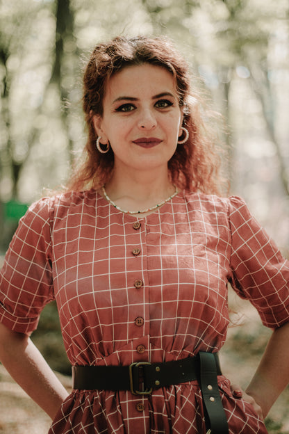 Woman in modest nursing red checkered dress forest