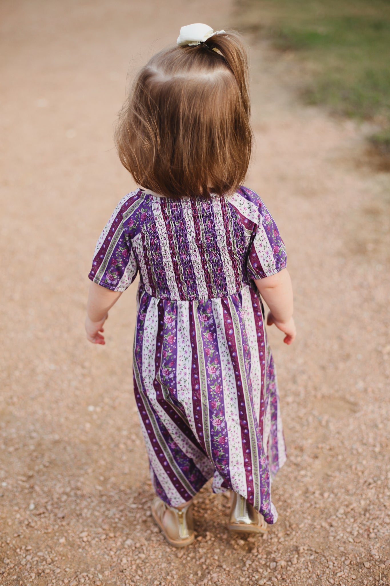 Child in purple striped modest dress