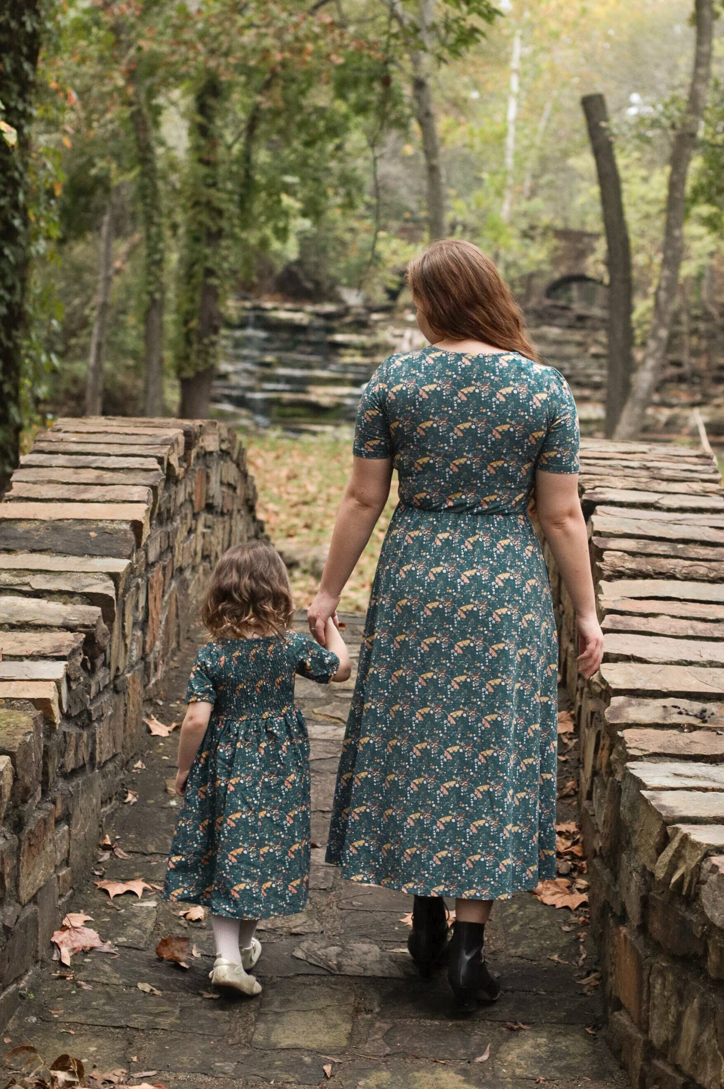 Woman in modest nursing dress with child outdoors
