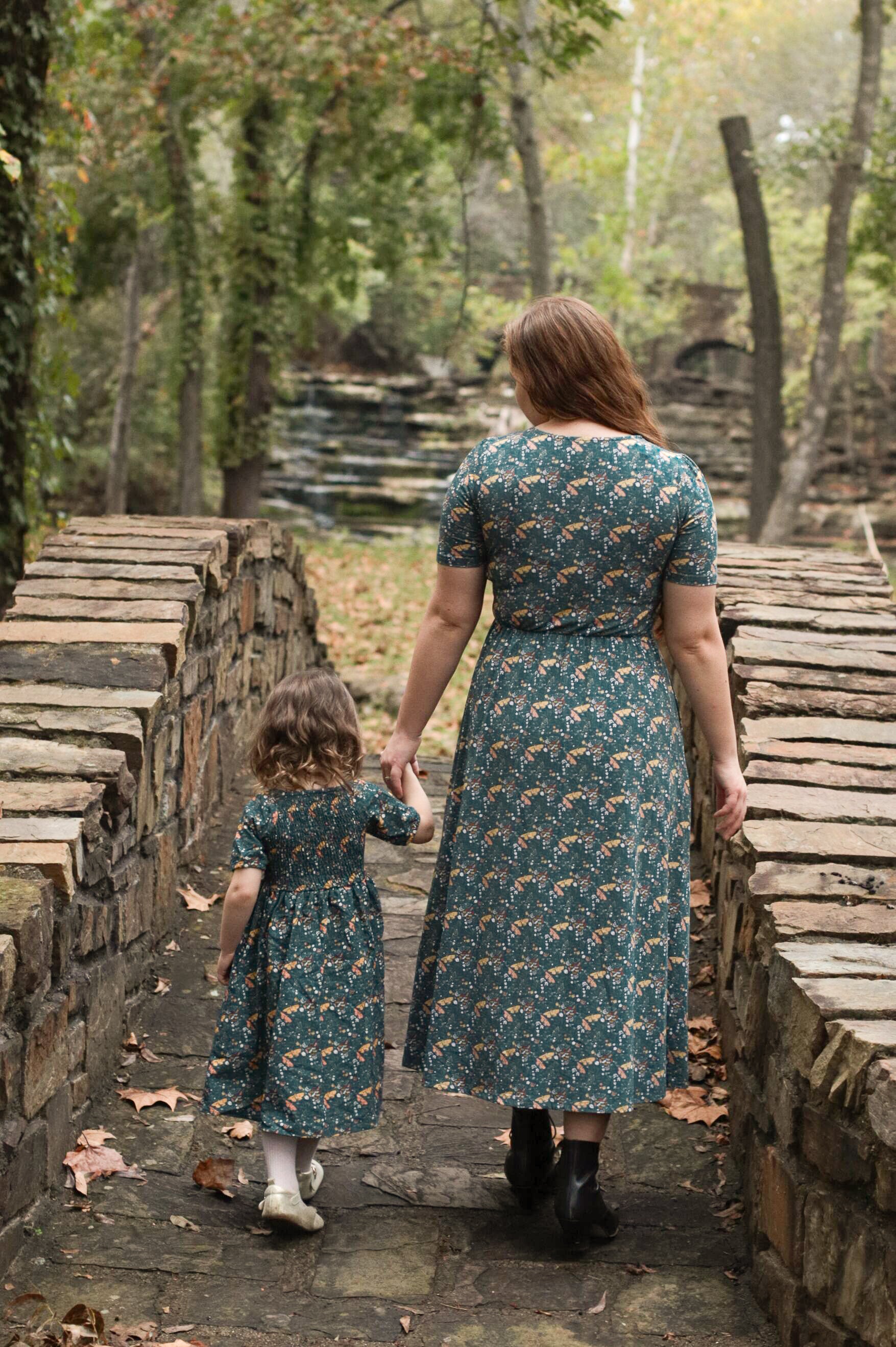 Woman in modest nursing dress with child outdoors