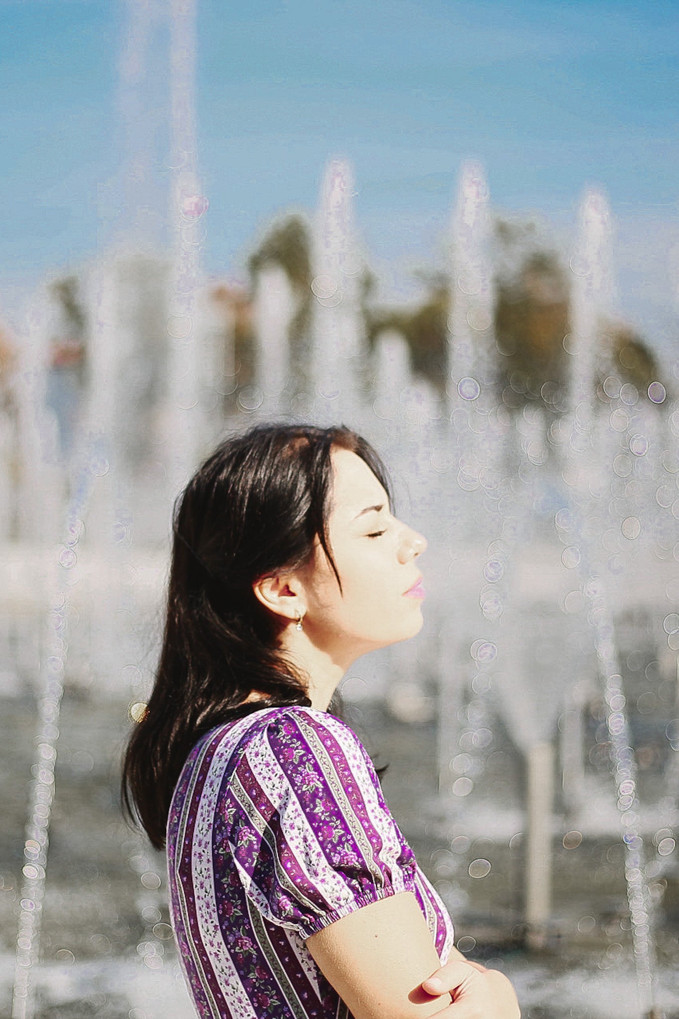 woman wearing a modest nursing purple and white striped dress