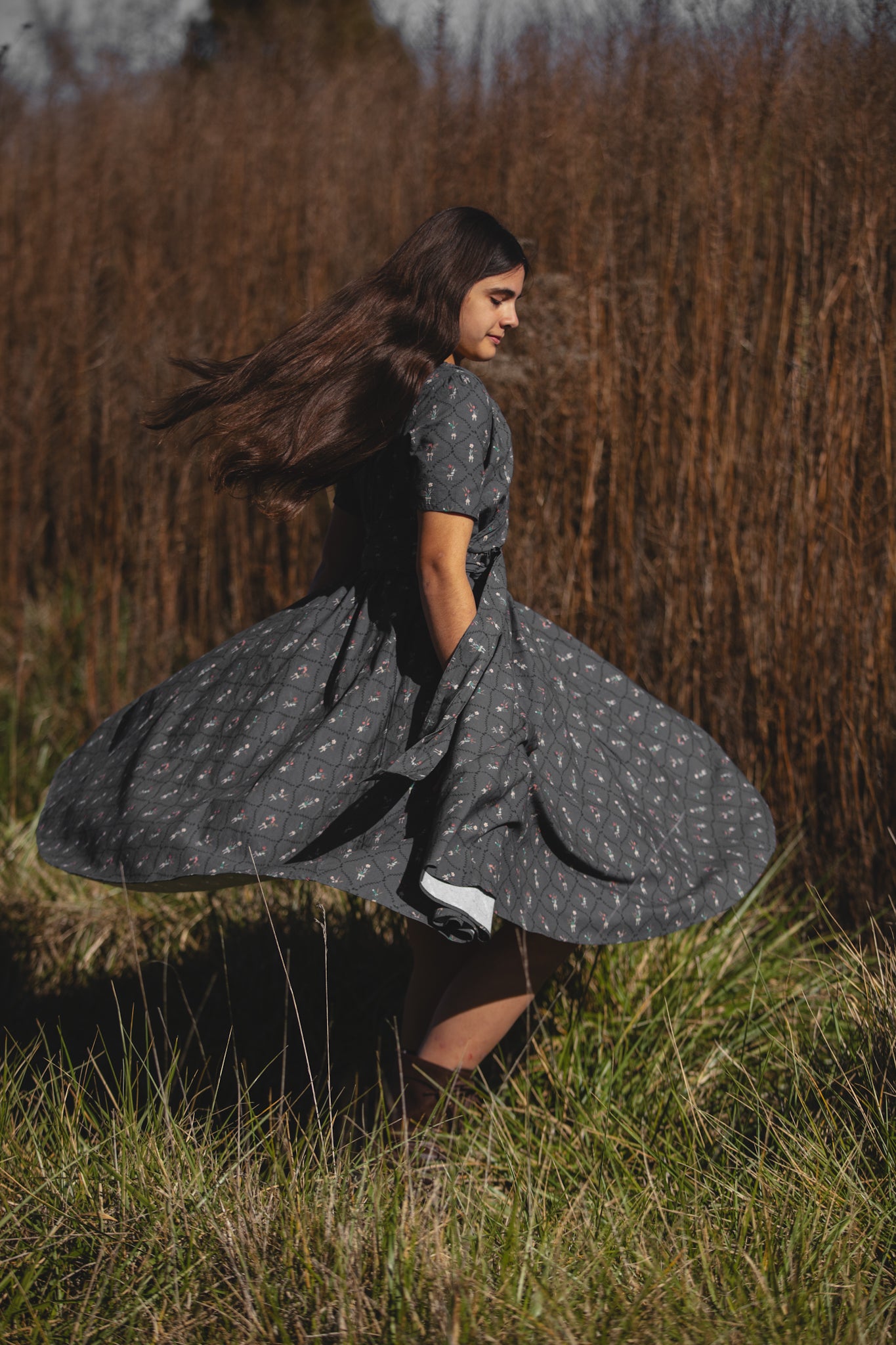 Modest nursing-friendly gray patterned dress twirling