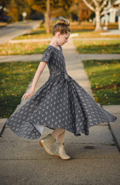 Modest young girl dark floral dress twirling