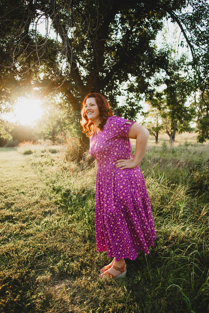 Woman in modest nursing dress in sunlit field