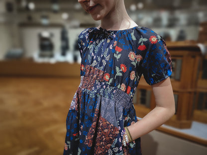young girl wearing a cute patchwork dress