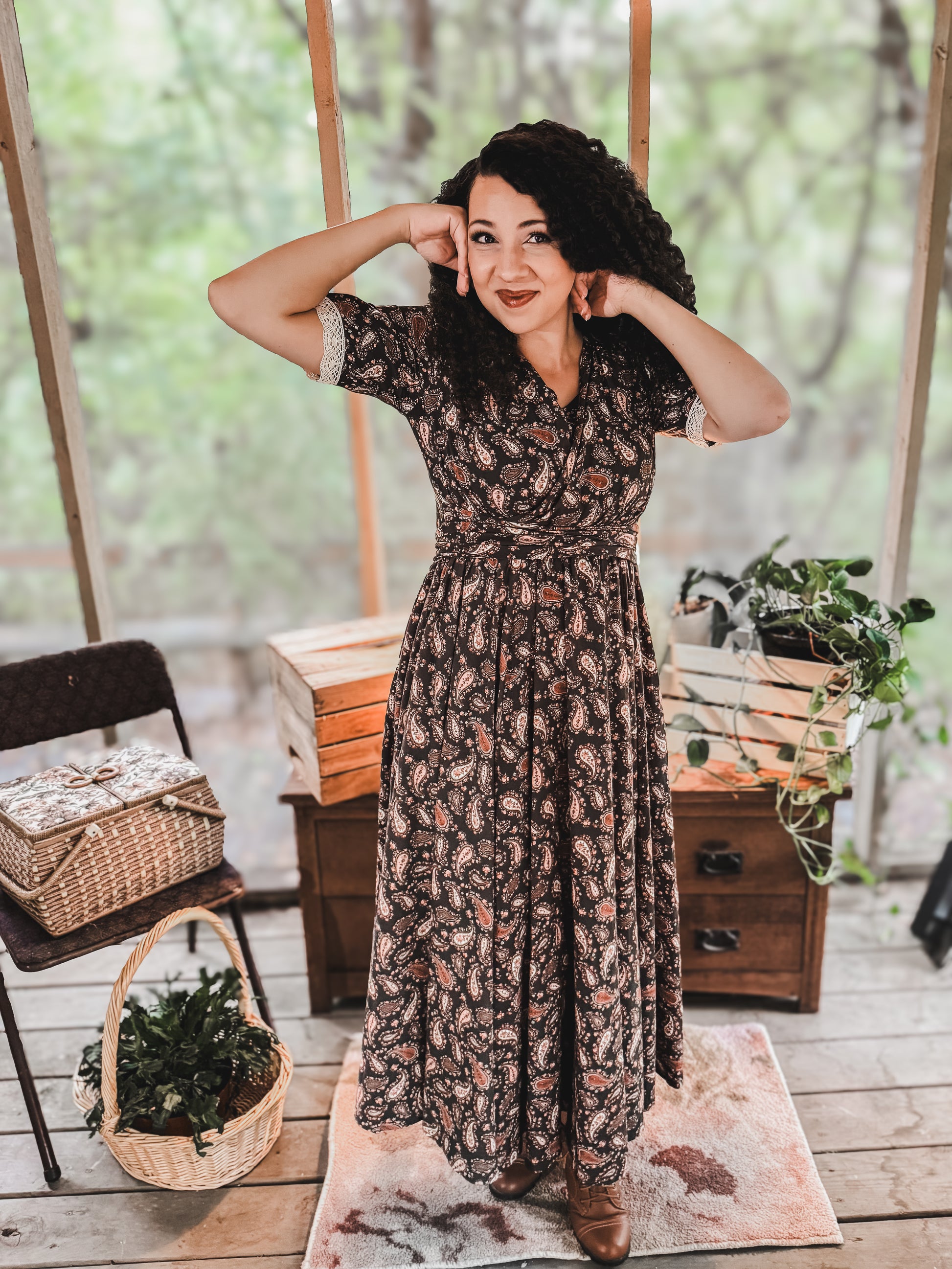 Woman in modest nursing dress in rustic garden setting
