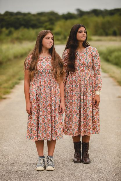 Women wearing patterned modest nursing dresses
