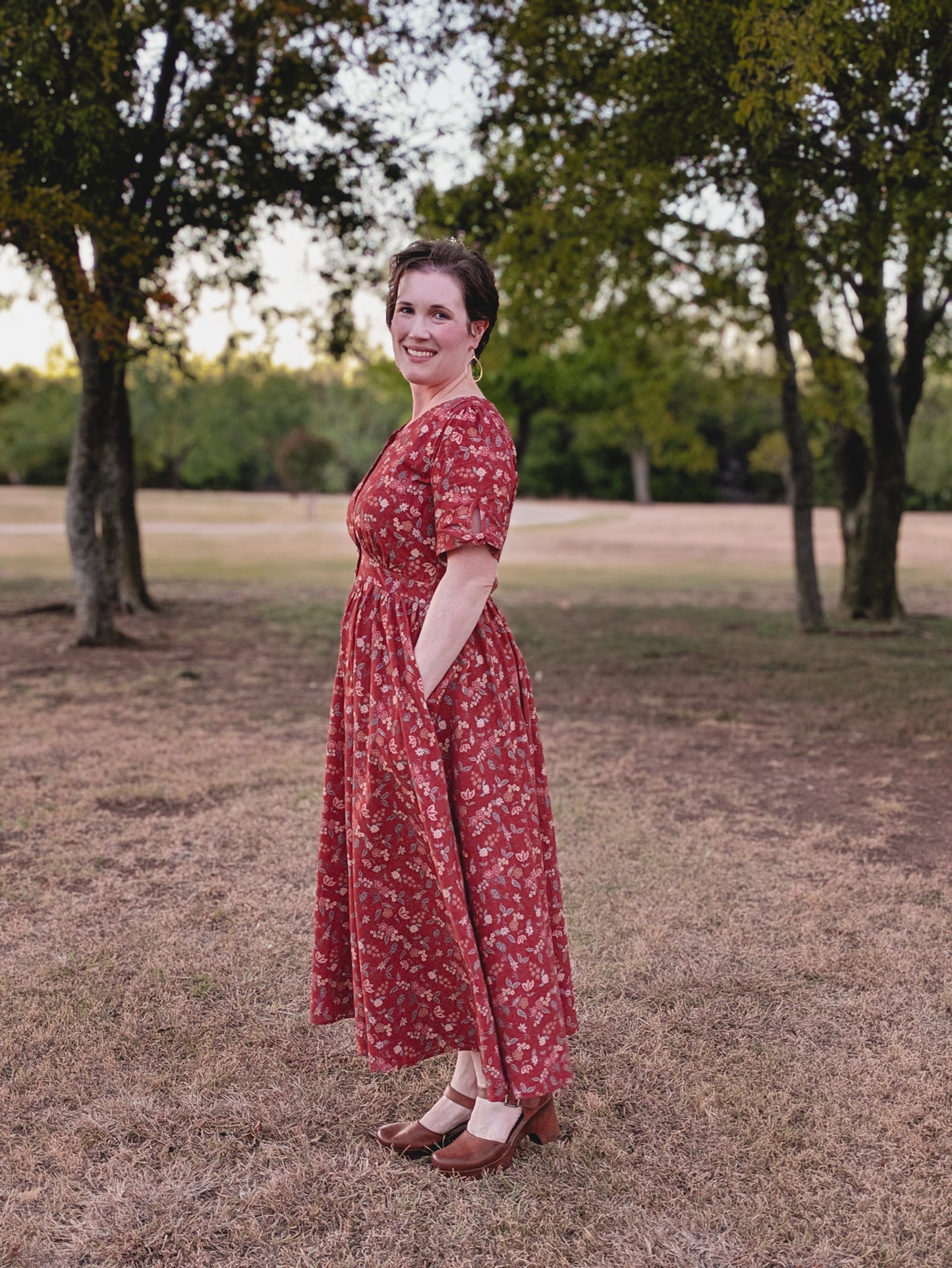 Woman in modest nursing red floral dress outdoors