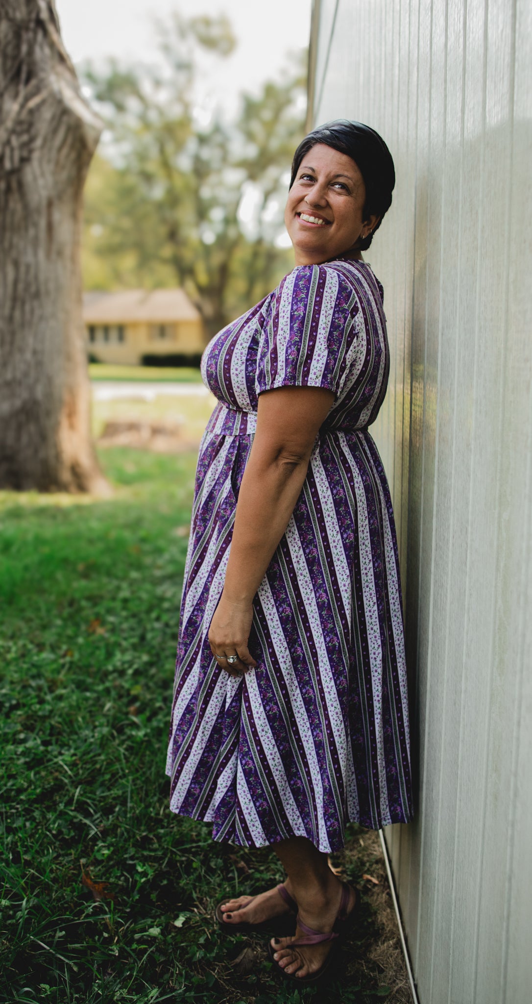 woman wearing a modest nursing purple and white striped dress