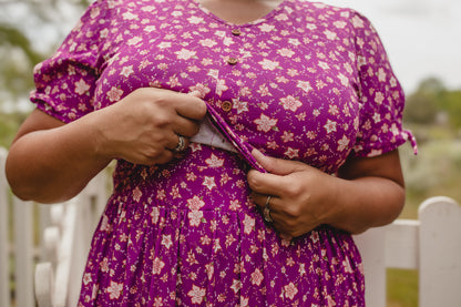 Person in modest nursing floral dress outdoors