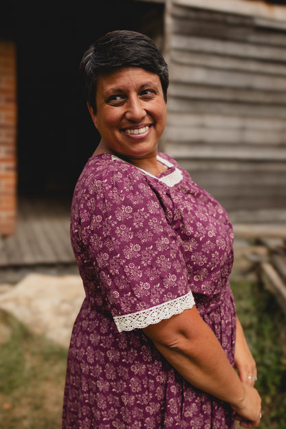 Woman in modest purple floral nursing dress