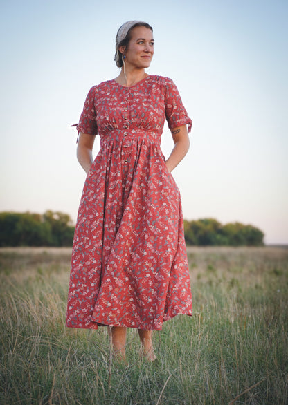 Woman in modest nursing red floral dress outdoors