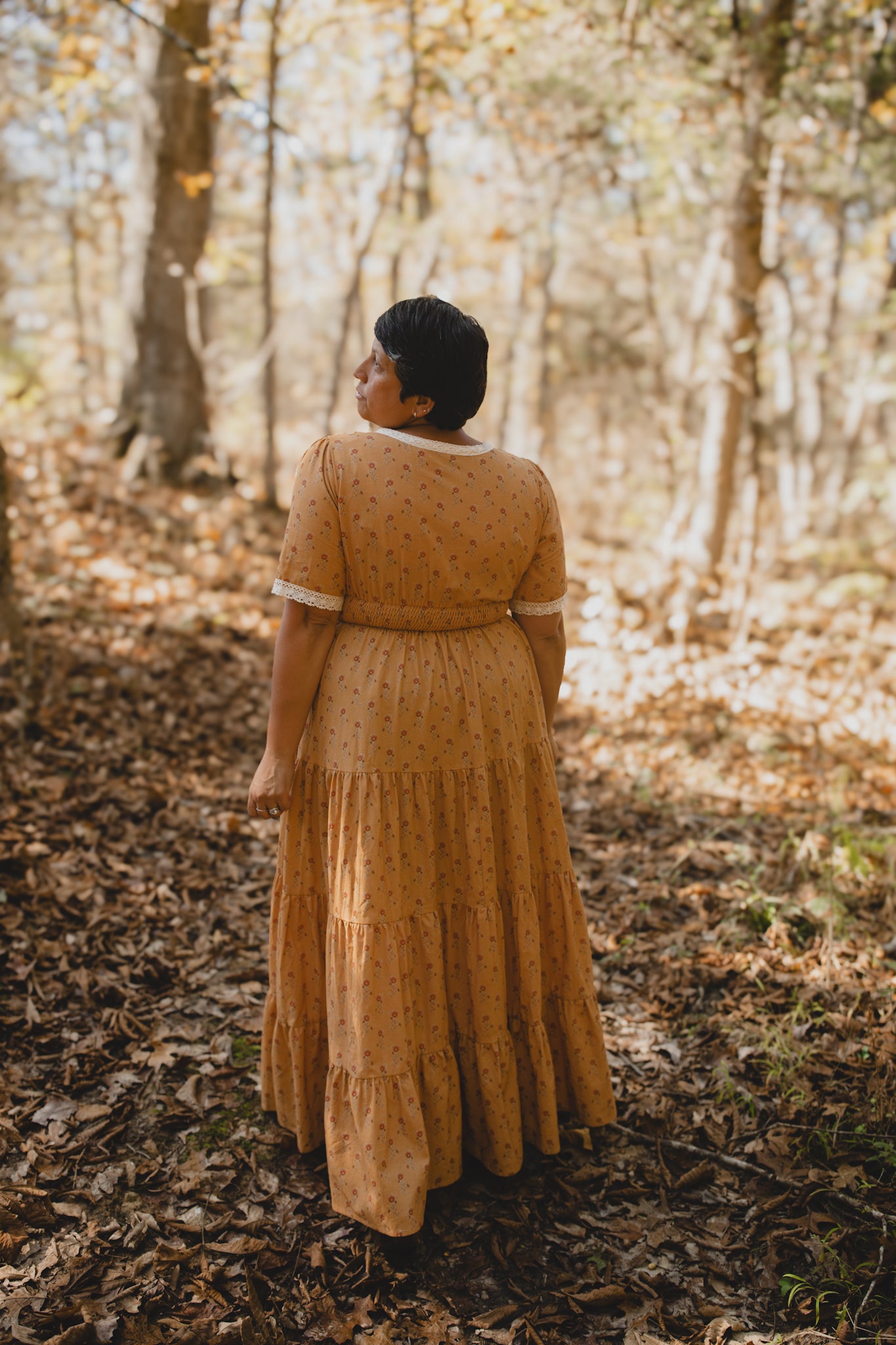 Woman in modest nursing dress standing forest