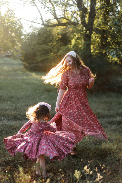 Two women in modest nursing red floral dresses