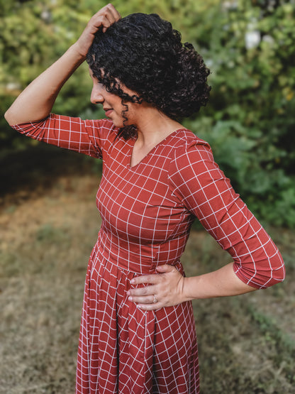 Woman in modest nursing copper windowpane maxi dress 