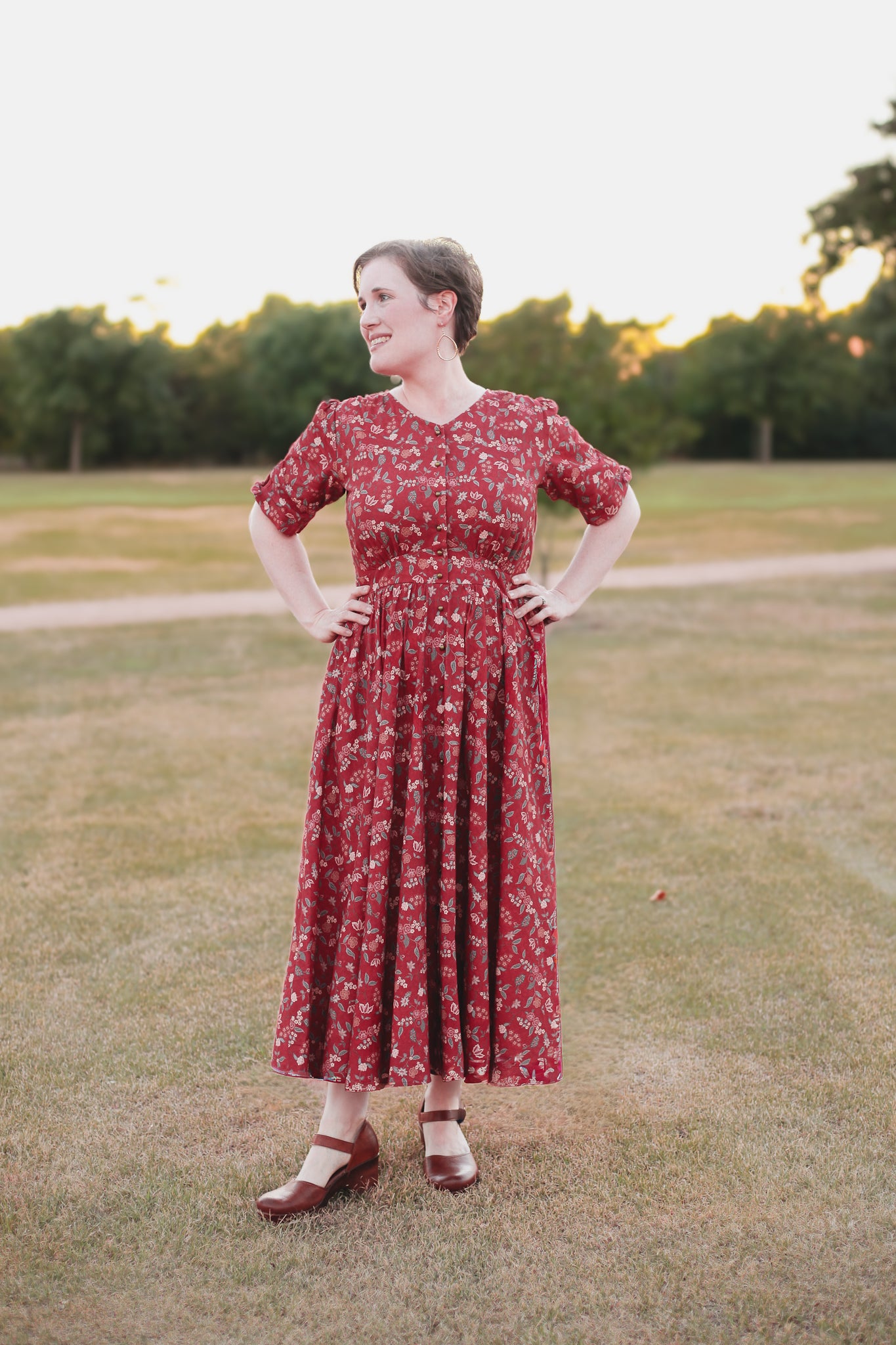 Woman in modest nursing red floral dress outdoors