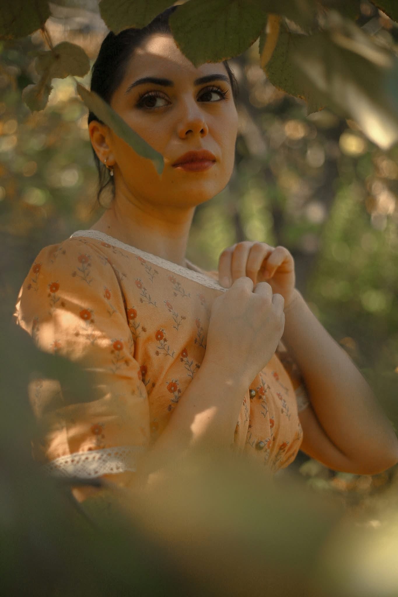 Woman in modest nursing dress holding leaf outdoors