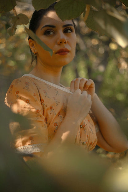 Woman in modest nursing dress holding leaf outdoors