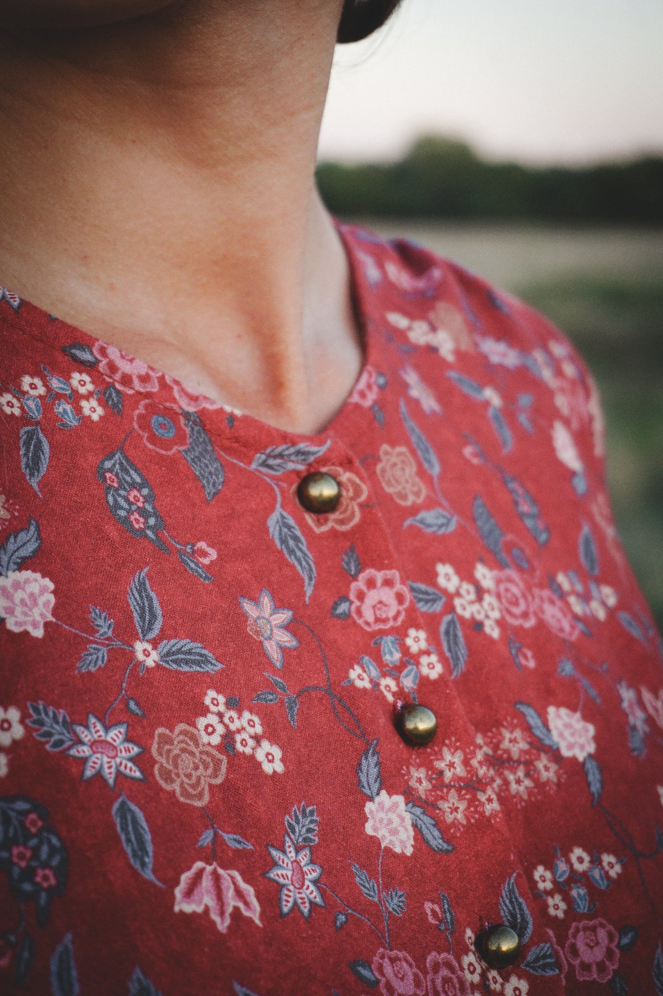 Red floral dress fabric detail with buttons