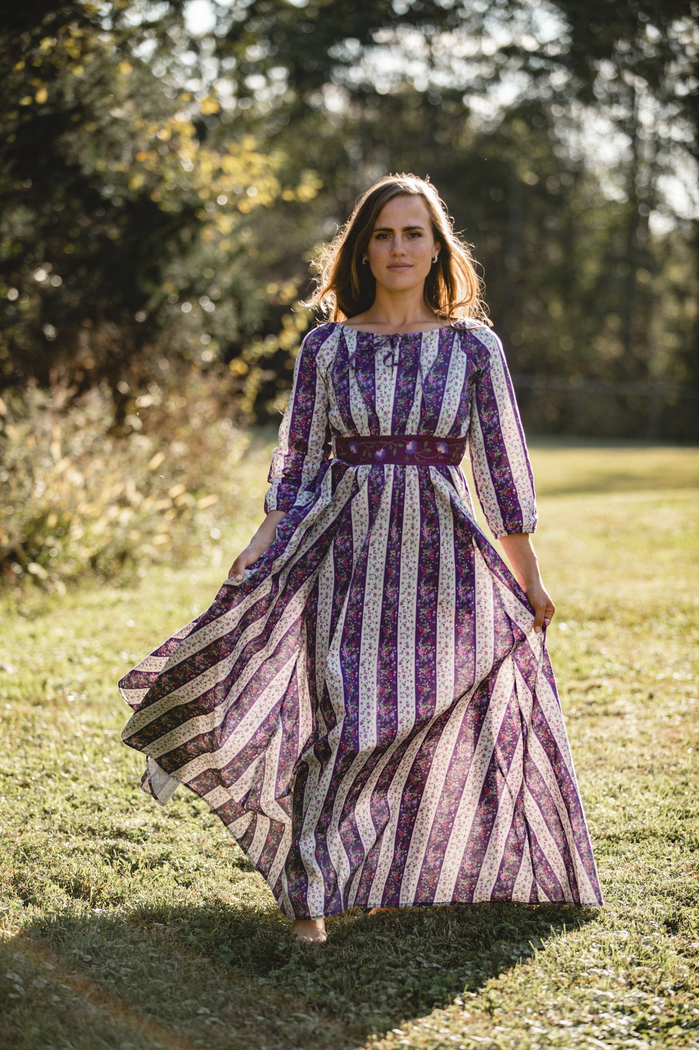 Woman in modest nursing dress in field