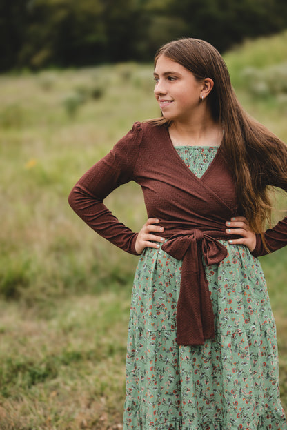 Woman in modest nursing outfit in field