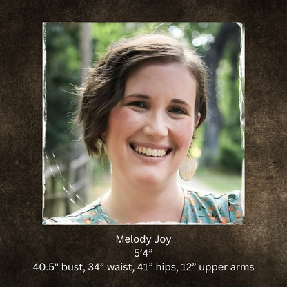 Woman with short hair smiling outdoors, with text about her measurements.