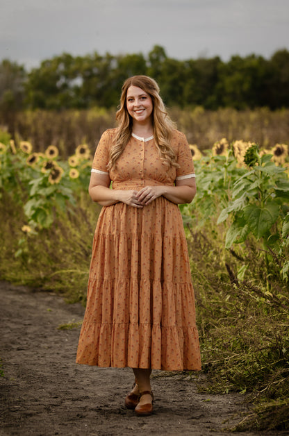 Woman in modest nursing dress sunflower field