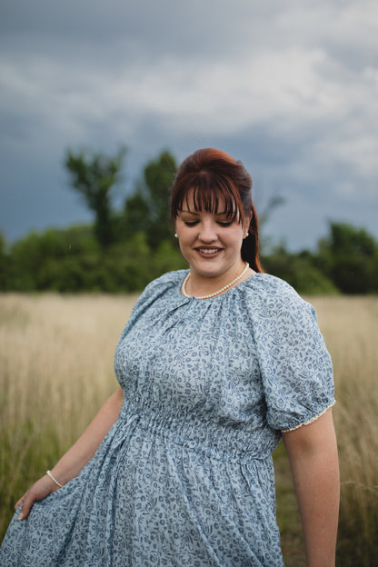 woman in a modest blue nursing dress