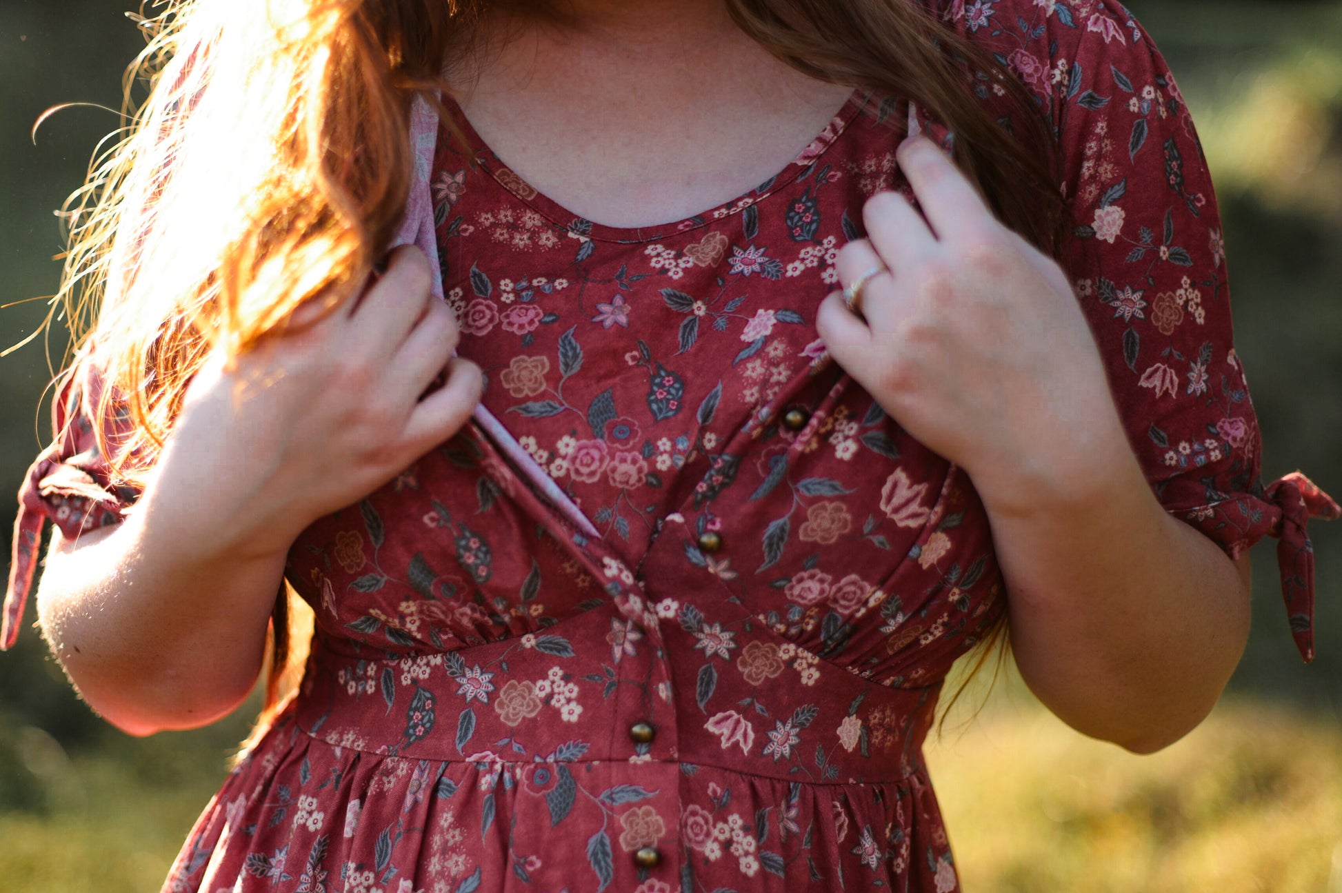 Woman in modest nursing red floral dress outdoors