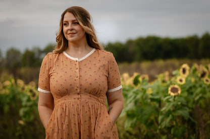 Woman in modest nursing dress sunflower field