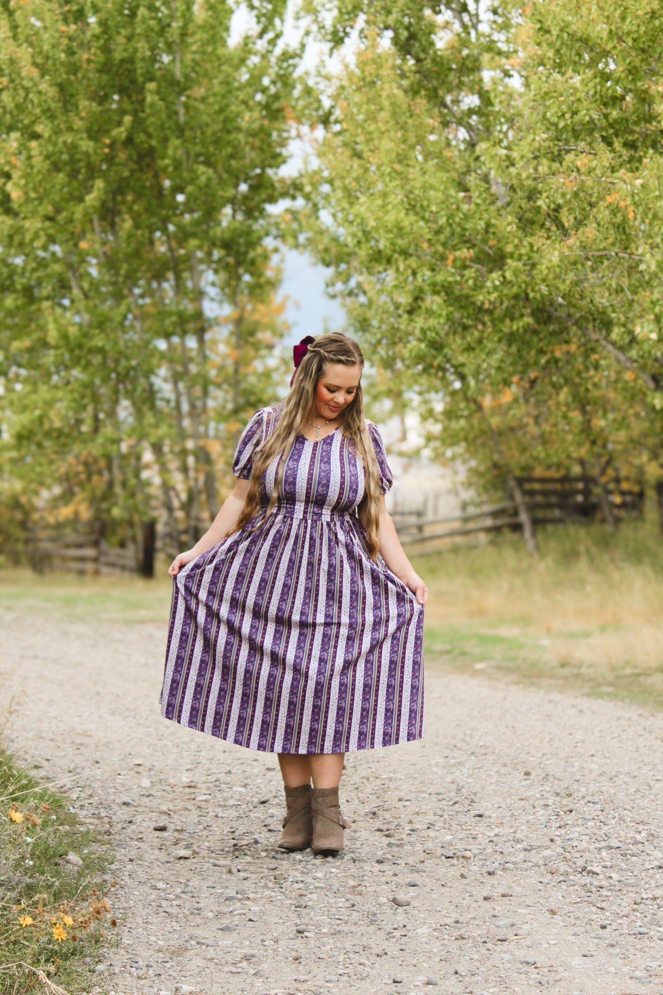 woman wearing a modest nursing purple and white striped dress
