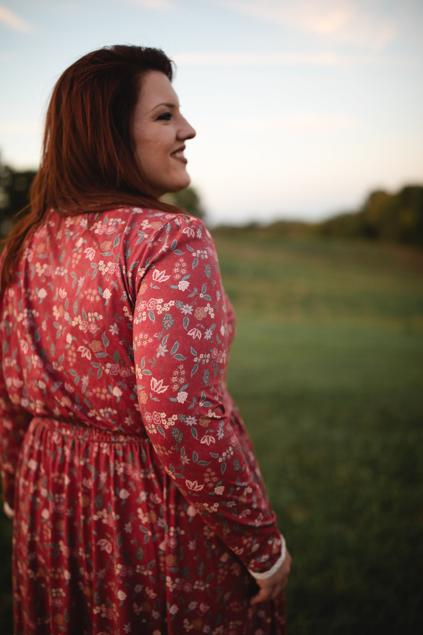 Woman in modest nursing red floral dress outdoors