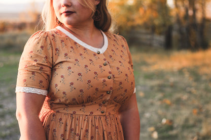 Woman in modest nursing dress outdoor setting