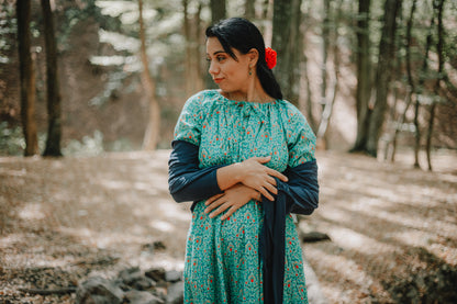 Woman in modest nursing green dress outdoors