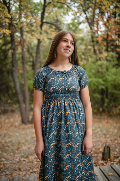 Woman in modest nursing dress in forest